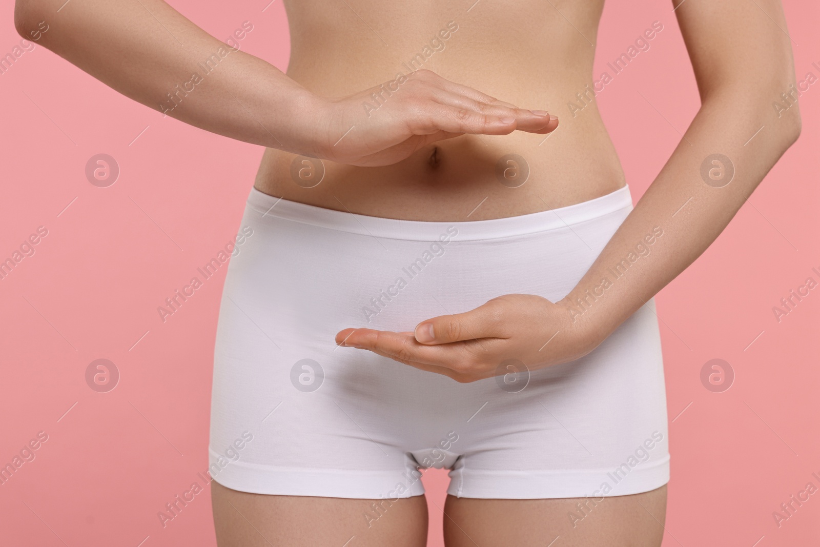 Photo of Woman holding something on pink background, closeup. Women's health