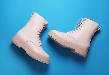 Pair of stylish leather shoes on light blue background, flat lay