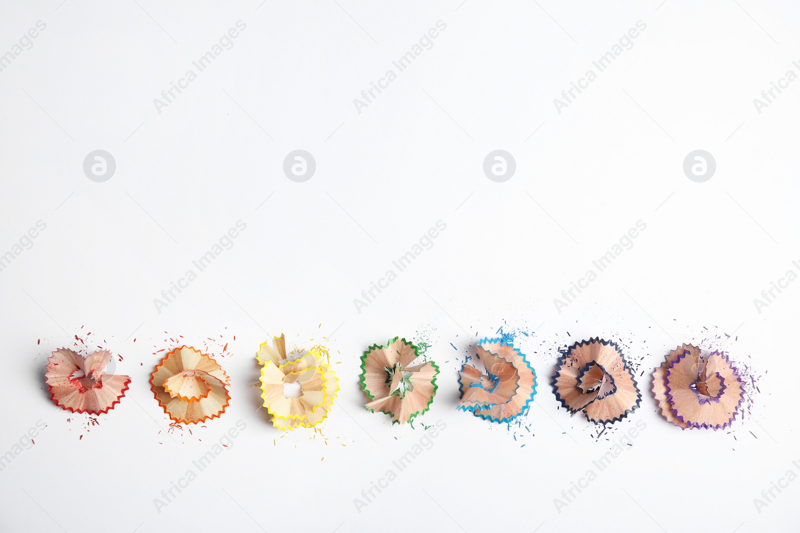Photo of Pencil shavings on white background, top view