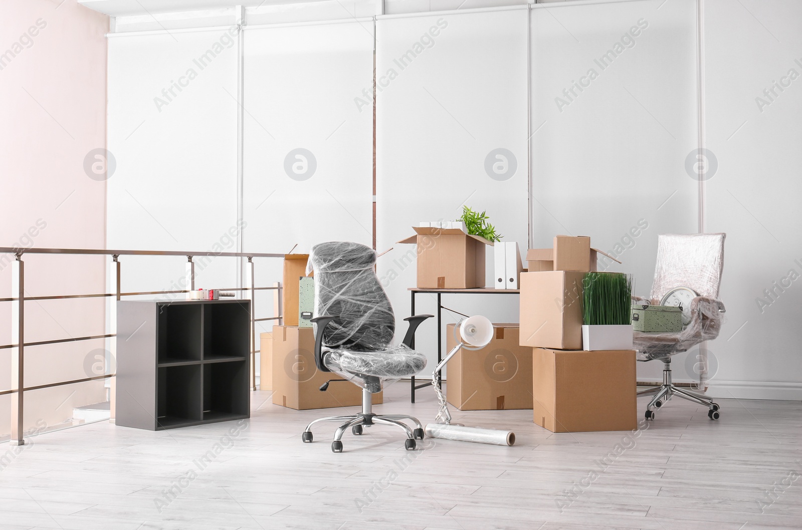 Photo of Carton boxes with stuff in room. Office move concept