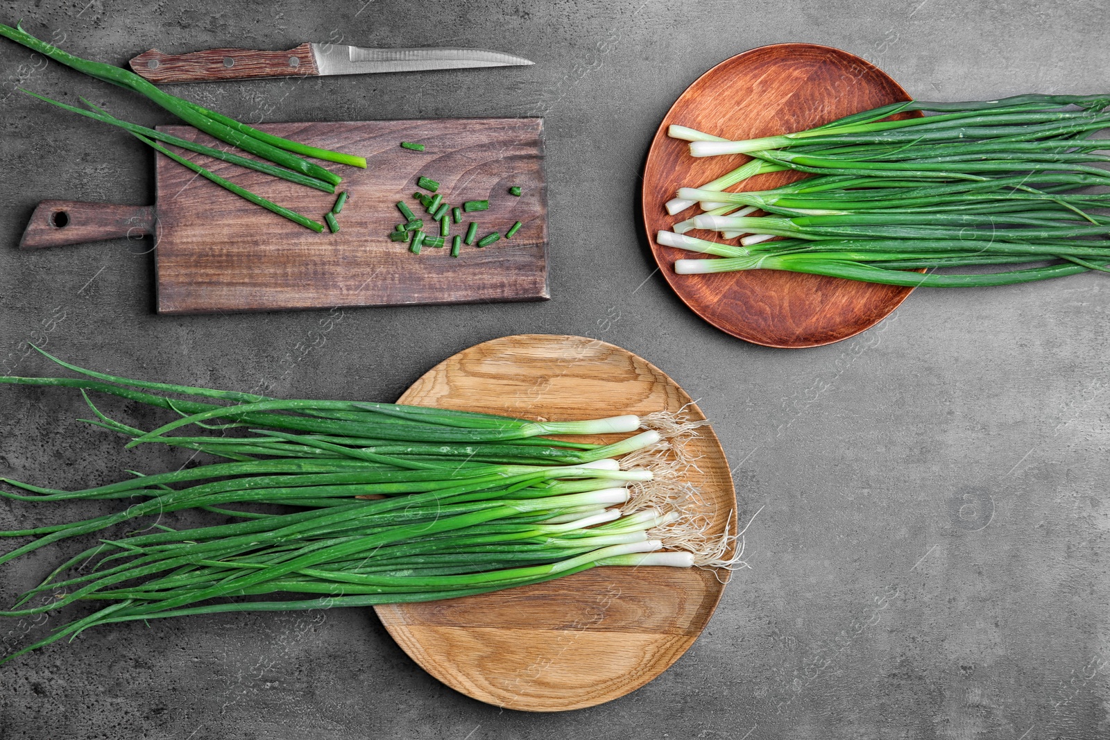 Photo of Beautiful composition with fresh green onion on table, top view