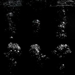 Image of Collage with air bubbles in water on black background