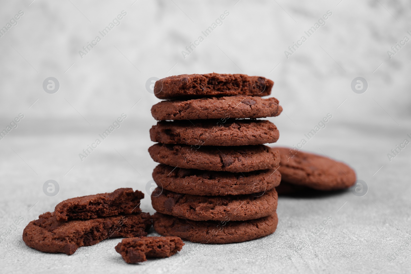 Photo of Tasty chocolate cookies on light grey table, closeup