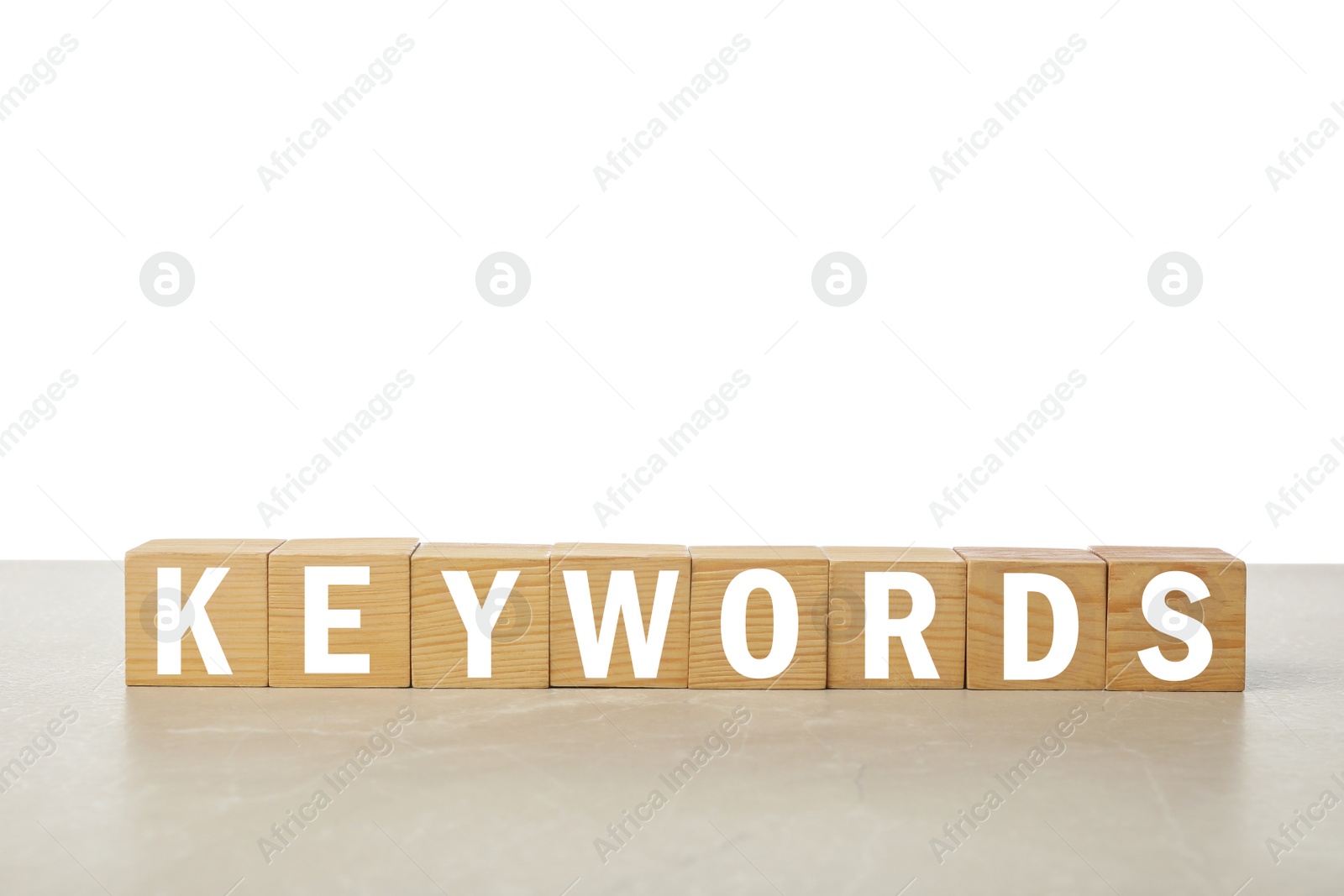 Photo of Wooden cubes with word KEYWORDS on light table