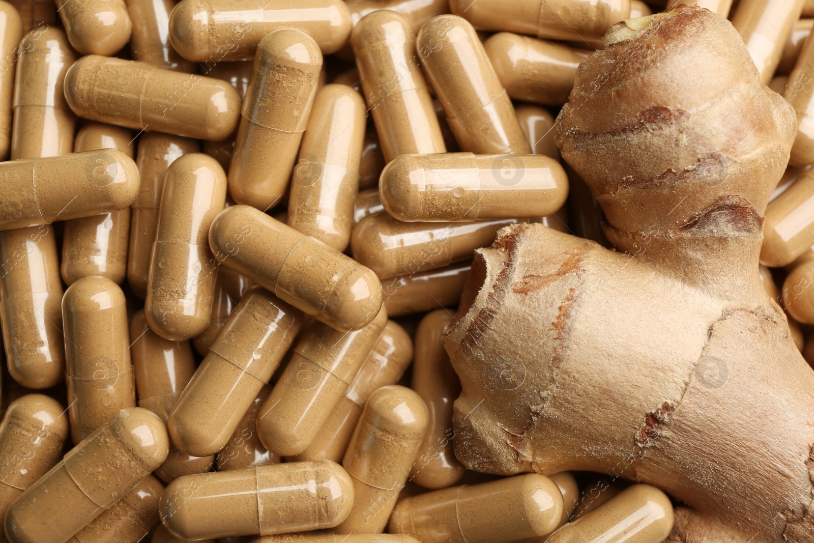 Photo of Raw root on pile of dry capsuled ginger, closeup