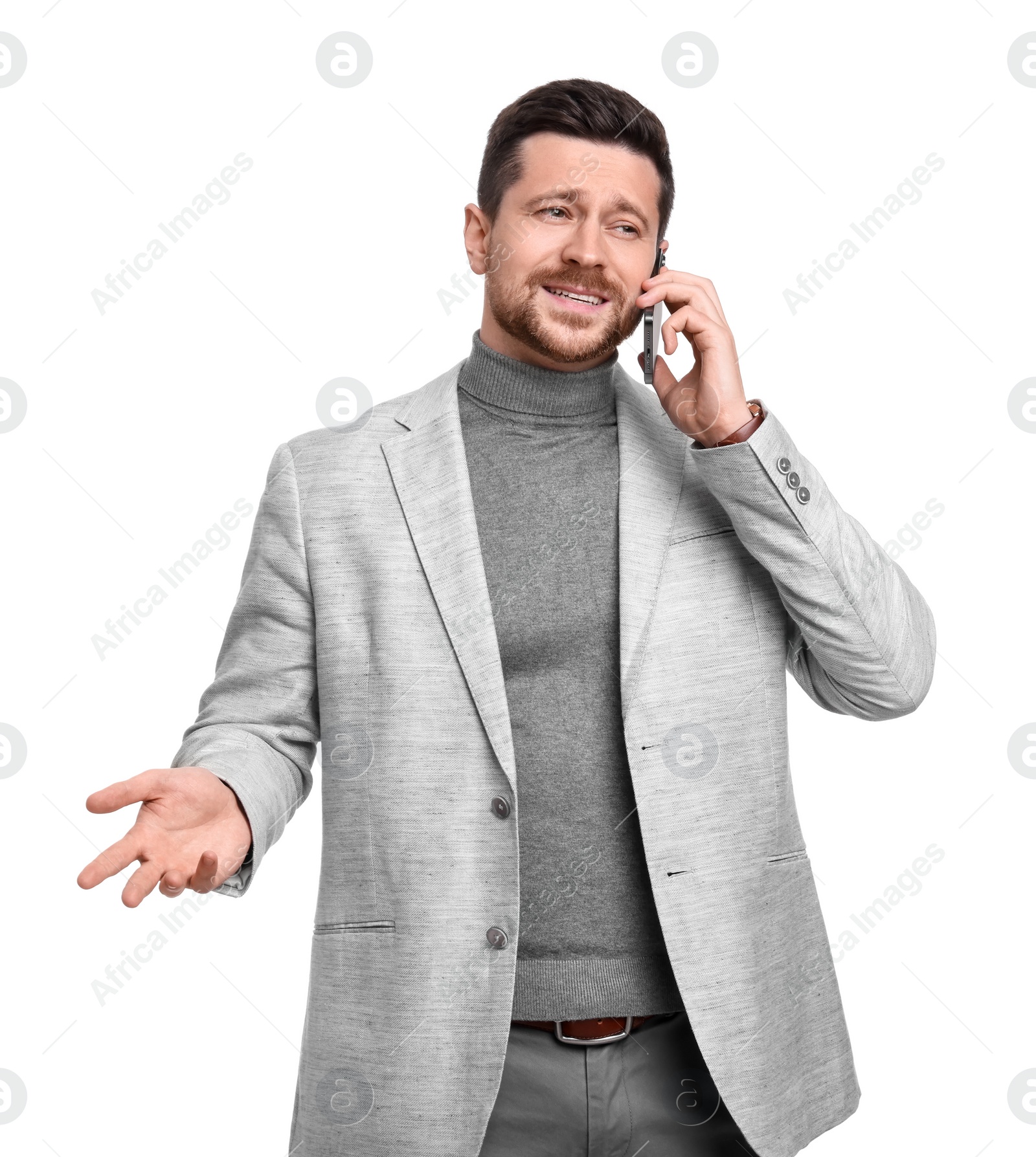 Photo of Handsome bearded businessman talking on smartphone against white background