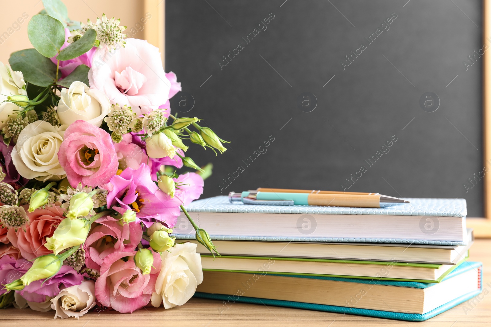 Photo of Composition with flowers for Teacher's day on wooden table