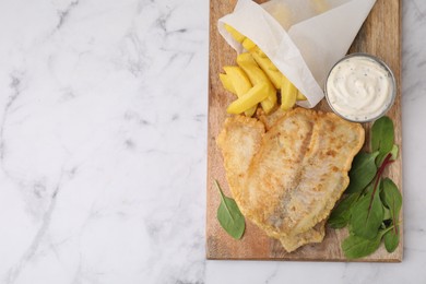 Photo of Delicious fish and chips with tasty sauce and mangold on white marble table, top view. Space for text