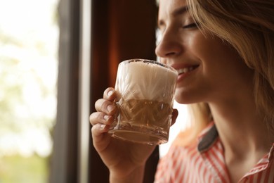 Photo of Young woman with glass of coffee in morning, closeup. Space for text