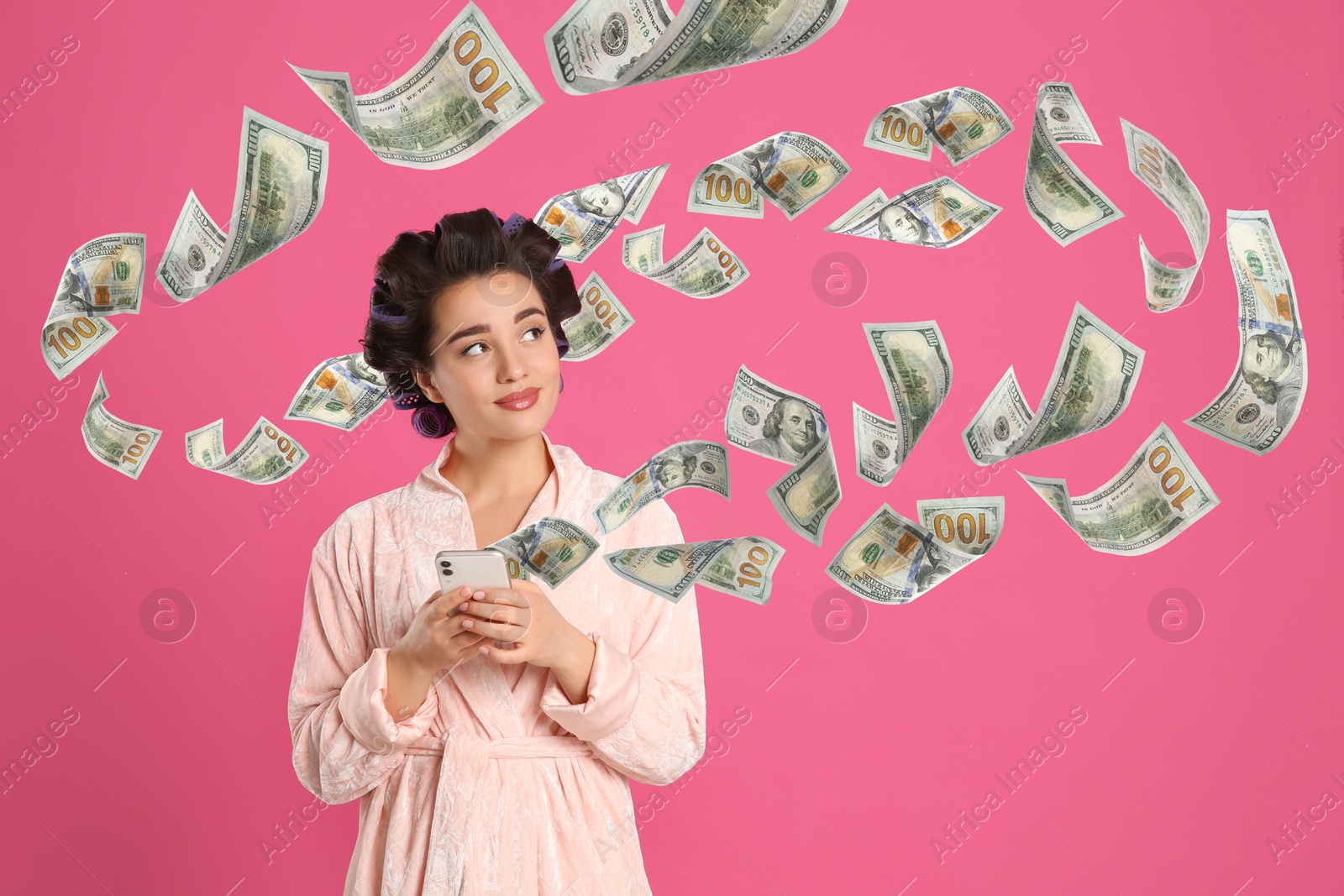 Image of Online payment. Woman buying something using mobile phone on pink background. Dollar banknotes flying out of gadget demonstrating process of money transaction