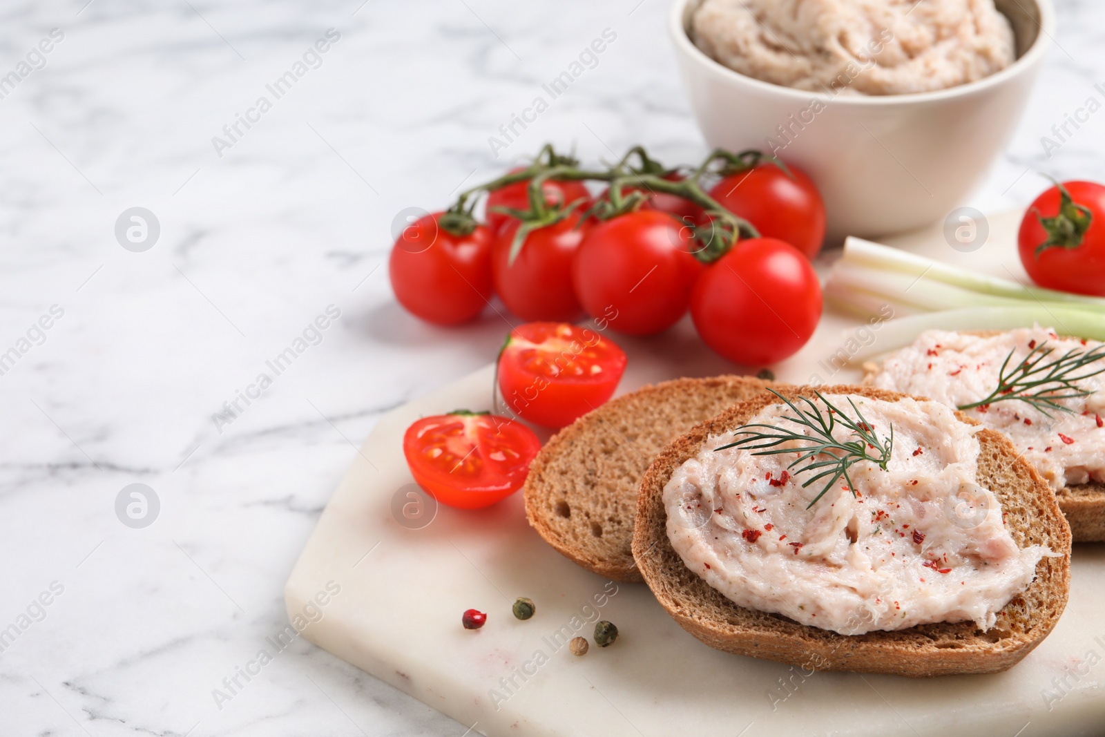 Photo of Sandwiches with delicious lard spread and vegetables on white marble table