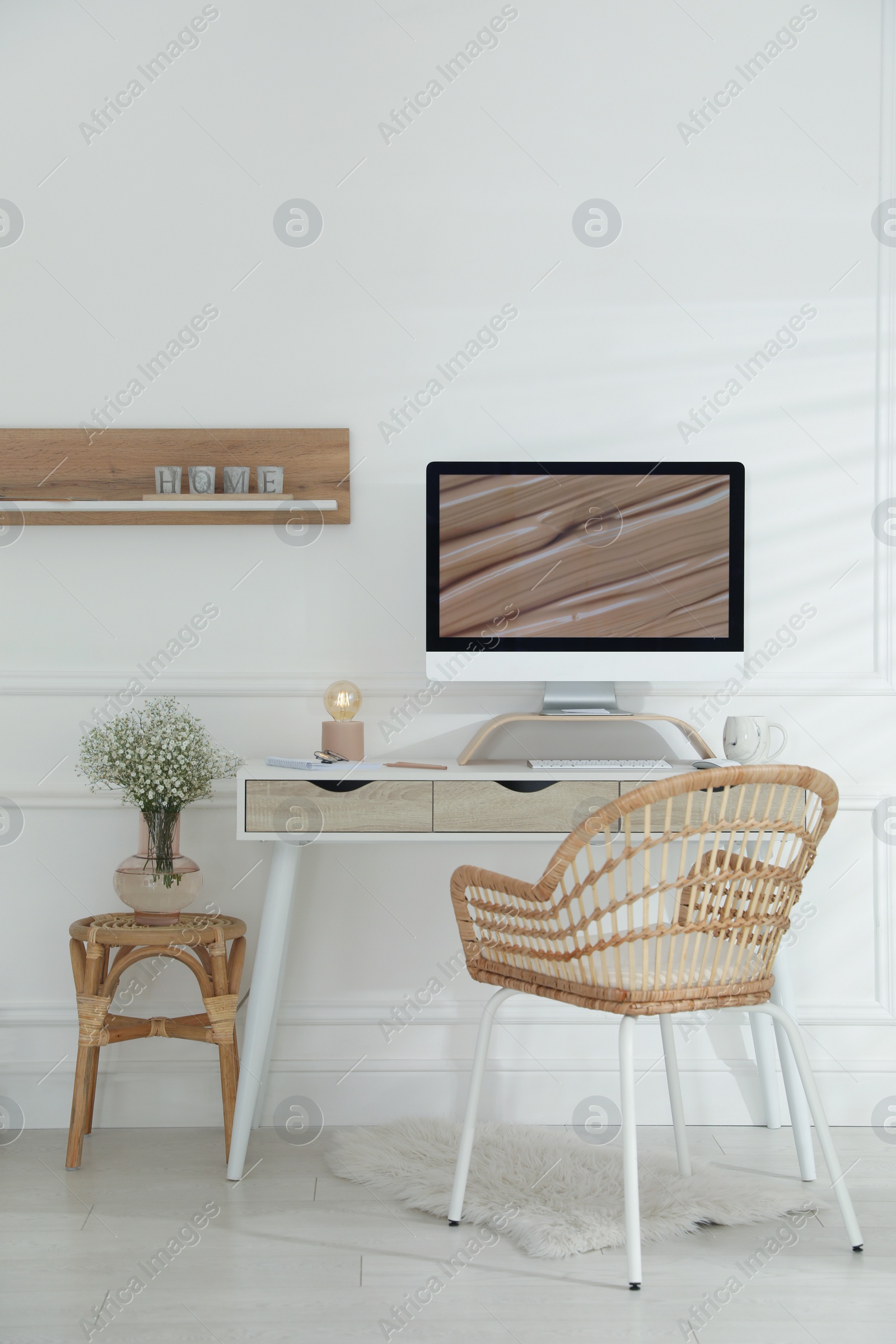 Photo of Comfortable workplace with modern computer and lamp in room. Interior design