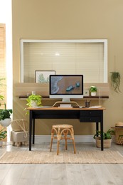 Light room interior with comfortable workplace near window