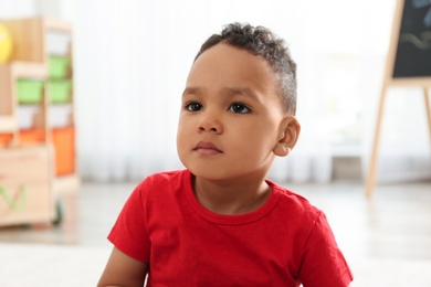 Photo of Portrait of cute little African-American boy in kindergarten