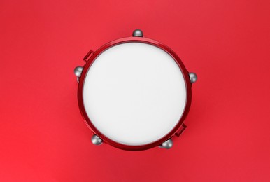 Photo of Drum on red background, top view. Percussion musical instrument