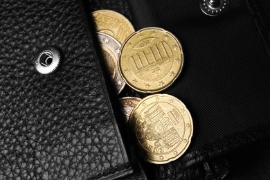Poverty. Black wallet and coins, top view