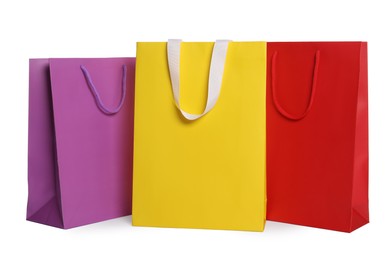 Photo of Colorful paper shopping bags isolated on white