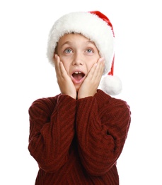 Photo of Emotional little child in Santa hat on white background. Christmas celebration