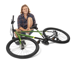 Photo of Young man with injured leg near bicycle on white background