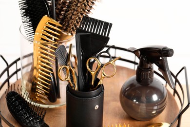 Photo of Set of hairdresser tools on table in salon, closeup