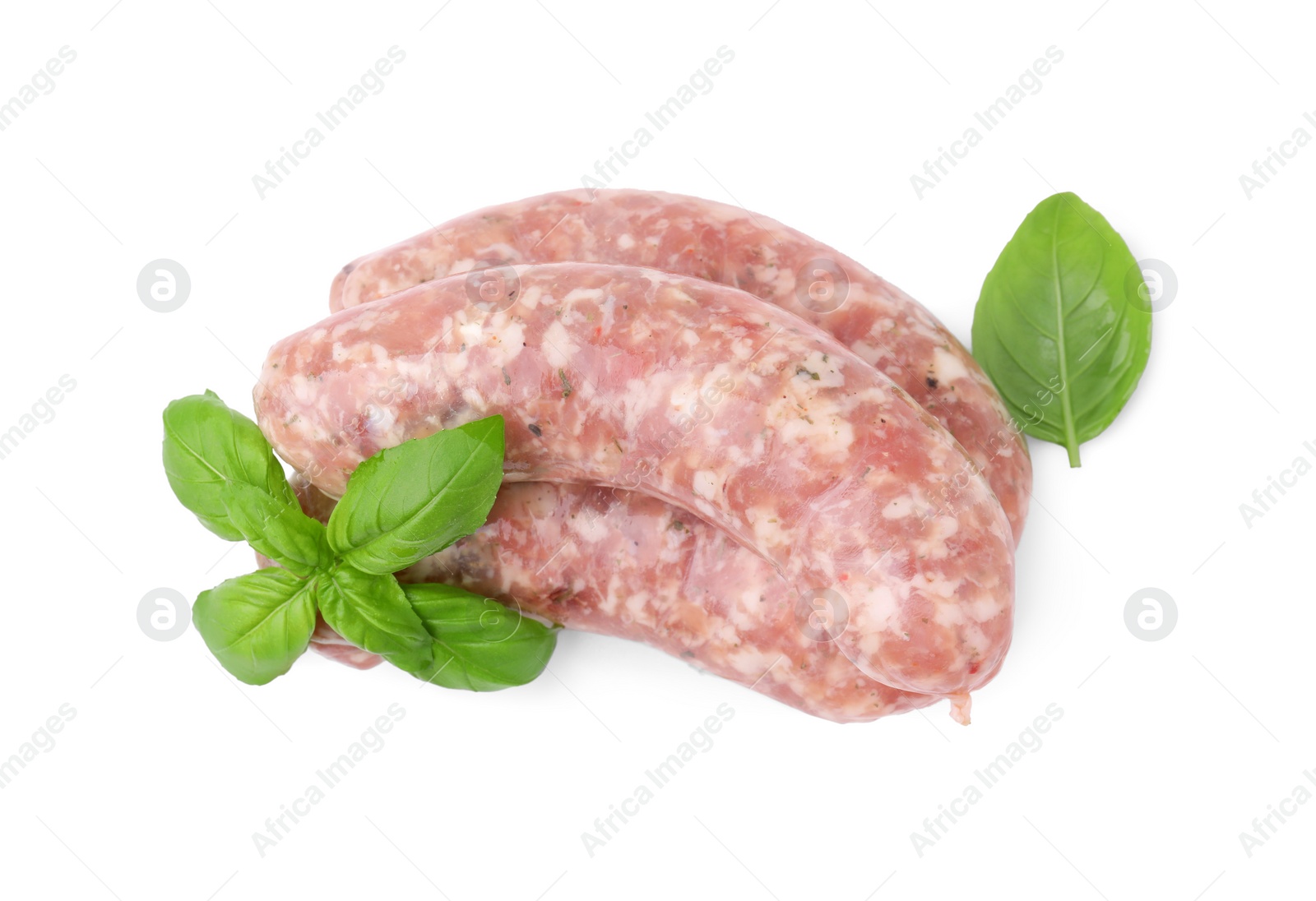Photo of Raw homemade sausages and basil leaves isolated on white, top view