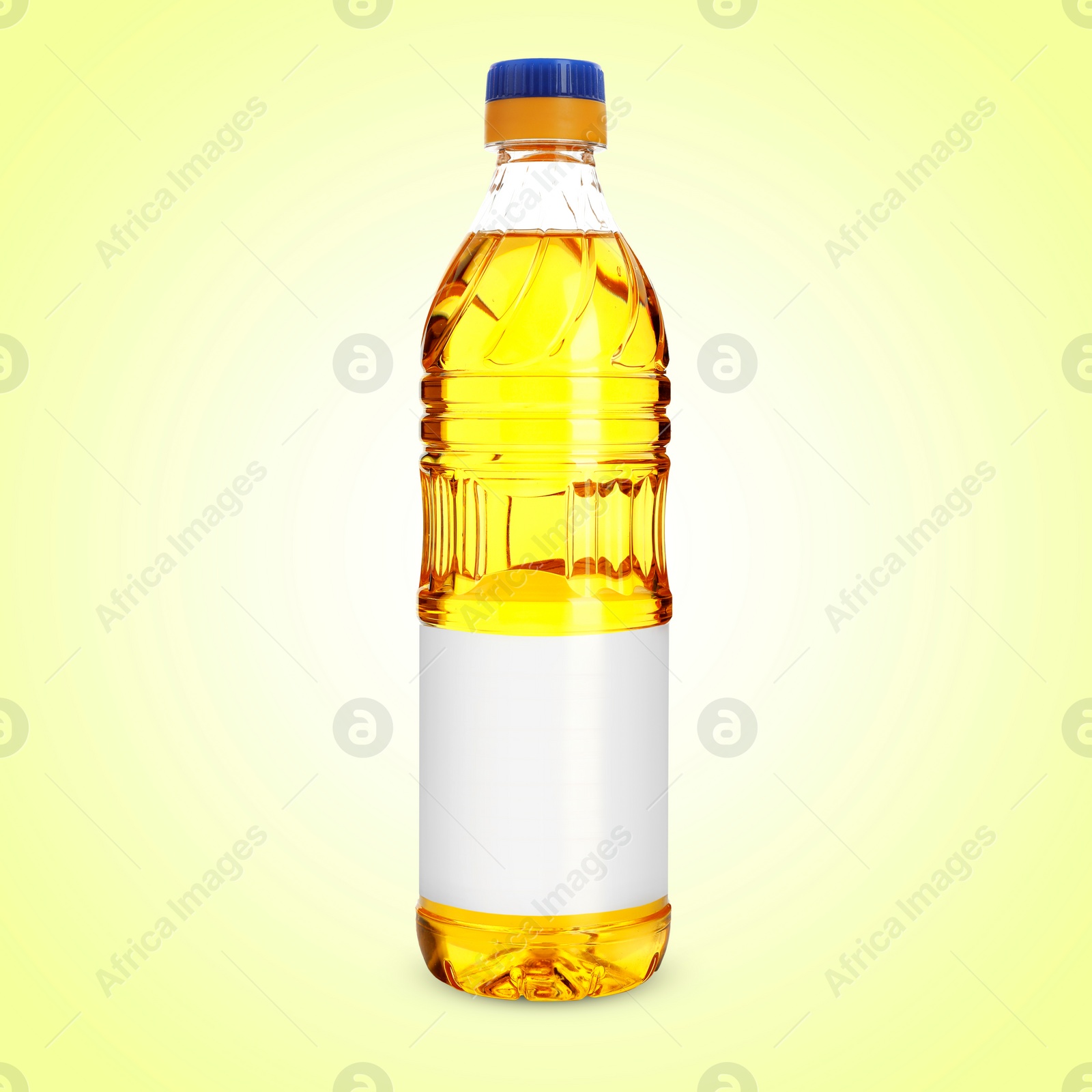 Image of Cooking oil in plastic bottle with empty label on light yellow background. Mockup for design