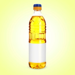 Image of Cooking oil in plastic bottle with empty label on light yellow background. Mockup for design