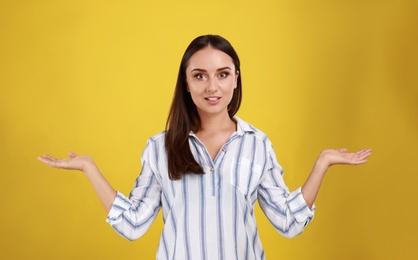 Photo of Emotional young woman in casual outfit on yellow background