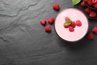 Photo of Delicious raspberry mousse with mint on black table, flat lay. Space for text