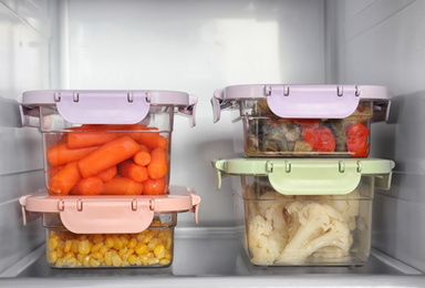 Photo of Lunchboxes with vegetables on shelf in refrigerator