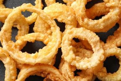 Photo of Homemade crunchy fried onion rings on table, top view