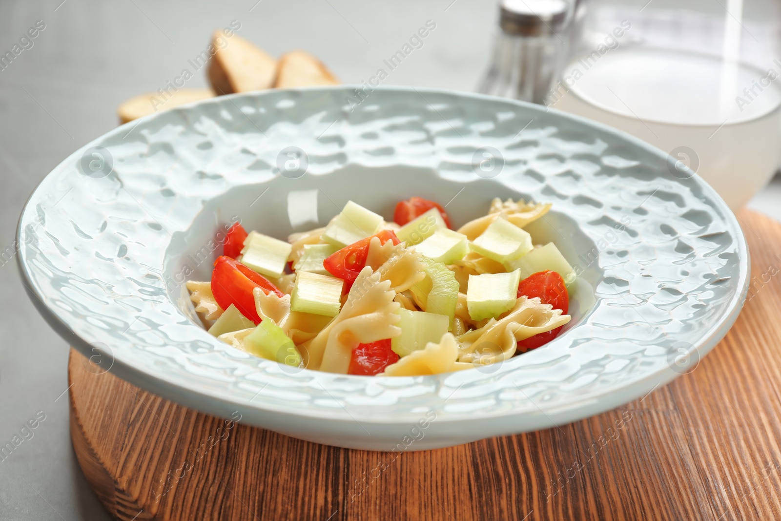 Photo of Tasty pasta salad with vegetables on table