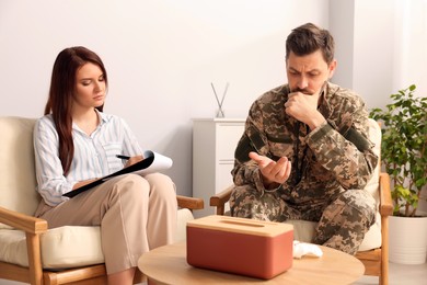 Psychologist working with military officer in office