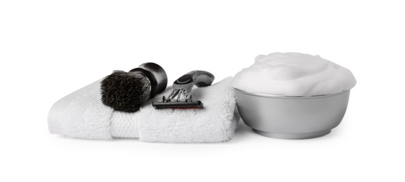 Shaving brush, foam, razor and towel on white background
