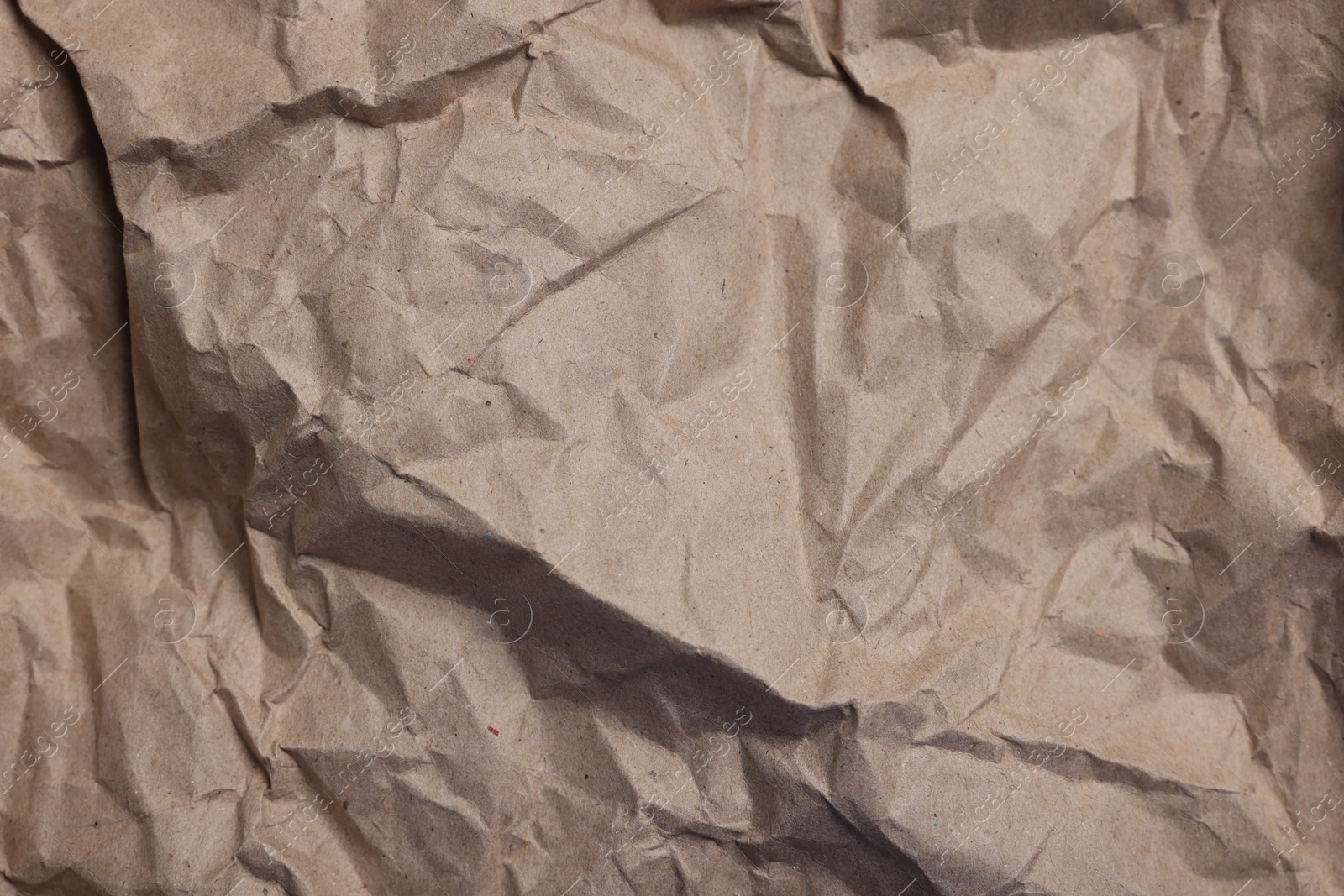 Photo of Texture of crumpled parchment paper as background, top view