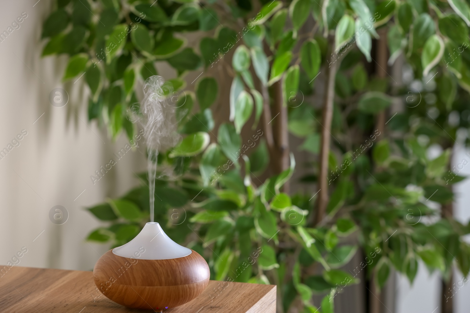 Photo of Aroma oil diffuser lamp on table indoors