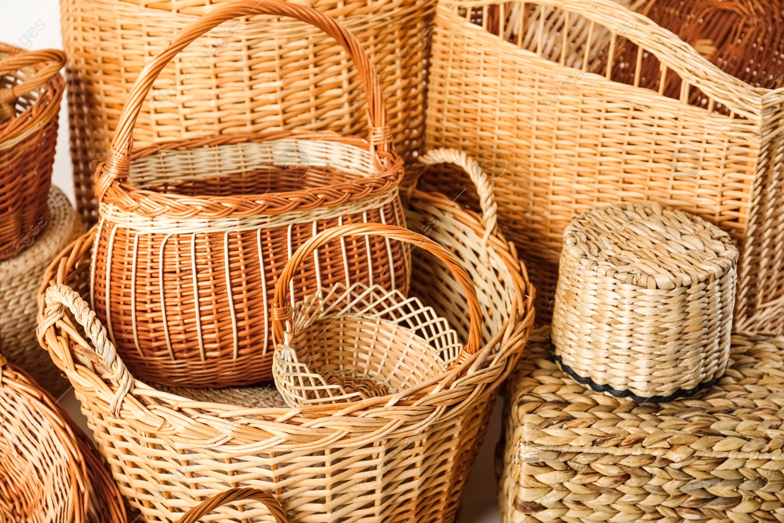 Photo of Many different wicker baskets made of natural material as background