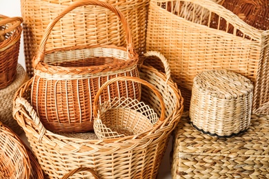 Photo of Many different wicker baskets made of natural material as background