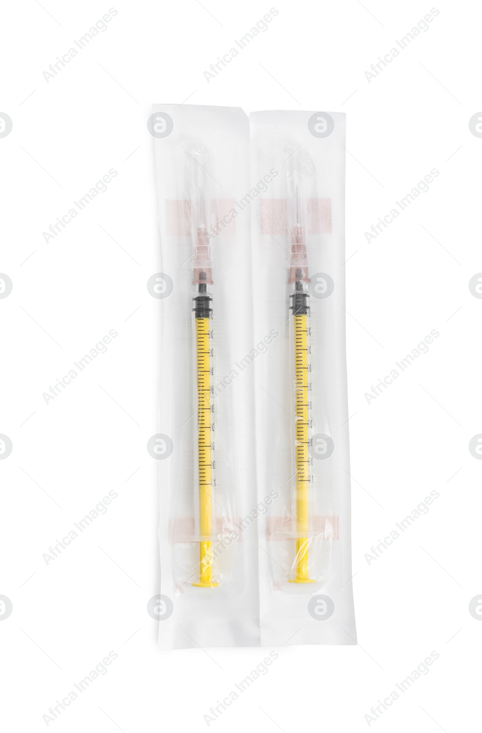 Photo of Packed disposable syringes with needles on white background, top view