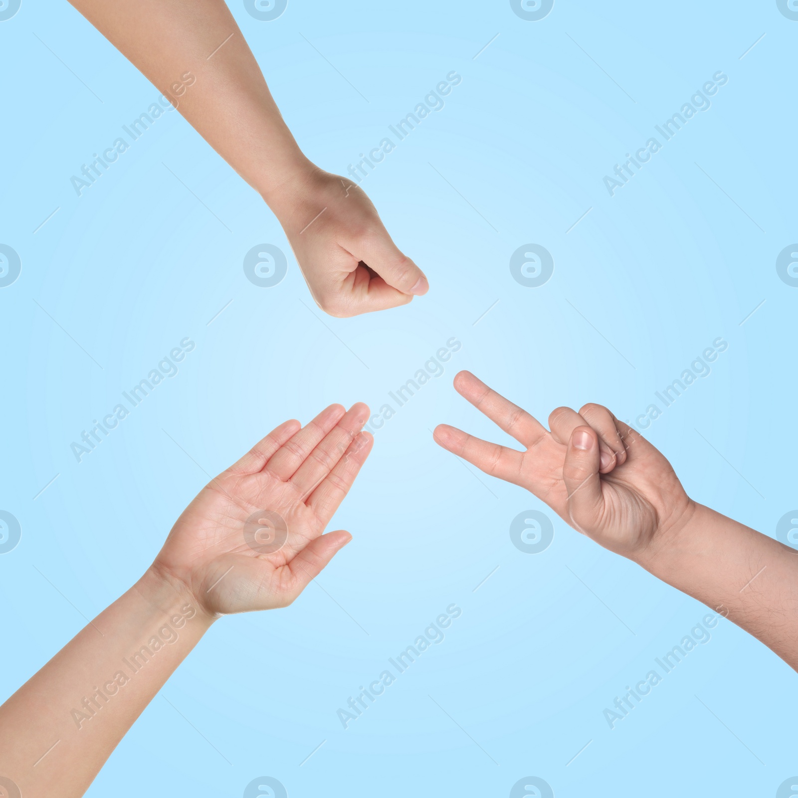 Image of People playing rock, paper and scissors on light blue background, top view