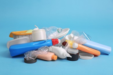 Pile of plastic garbage on light blue background