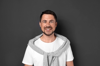 Photo of Portrait of handsome man on dark background