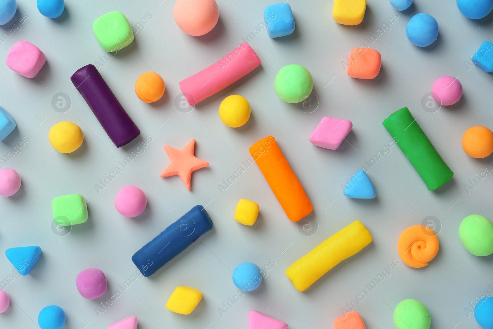 Photo of Different color play dough on light grey background, flat lay