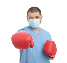 Photo of Doctor with protective mask and boxing gloves on white background. Strong immunity concept