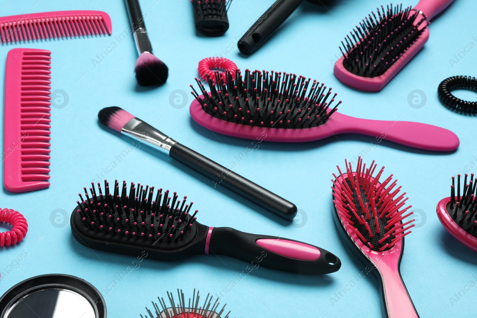 Photo of Composition with modern hair combs and brushes on light background