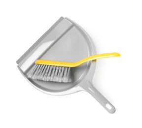 Plastic hand broom and dustpan isolated on white, top view