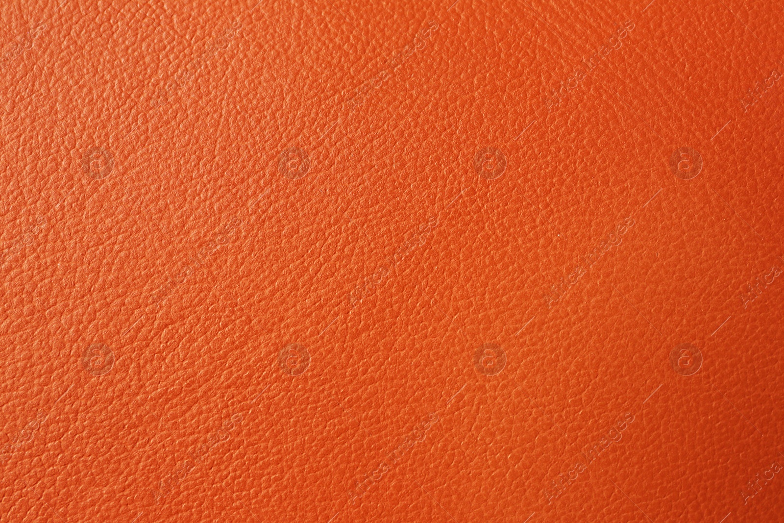 Photo of Texture of orange leather as background, closeup