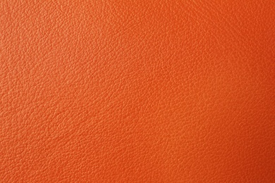 Texture of orange leather as background, closeup