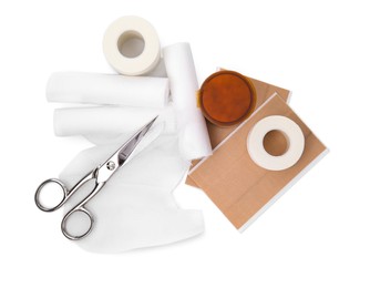 Photo of Bandage rolls and medical supplies on white background, top view