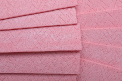 Photo of Sticks of pink chewing gum as background, top view